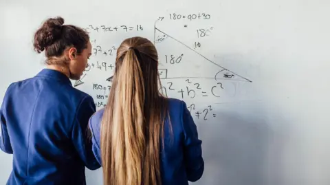 Getty Images Pupils doing maths on a whiteboard