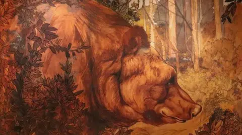 A water colour painting shows a bear in a forest with leaves in front of it. The bear's fur is brown and the forest is sunlit with the tree trunks visible. The bear fills most of the painting and looks sleepy and gentle.