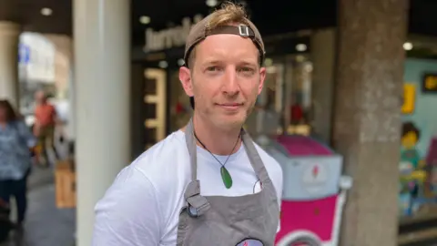 Martin Giles/BBC Jon Lee, ice cream seller with his ice cream cart