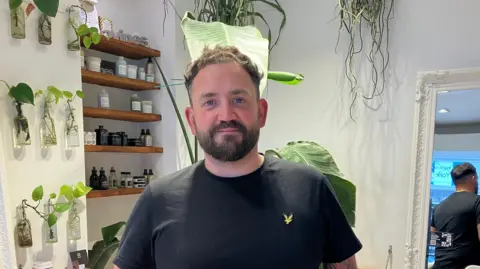 BBC / Naj Modak Hairdresser Chris Wood is pictured in his salon