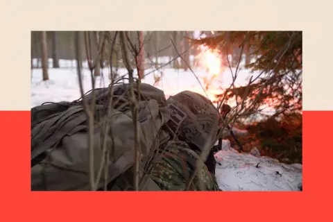 A soldier in the snow with a flame in the background