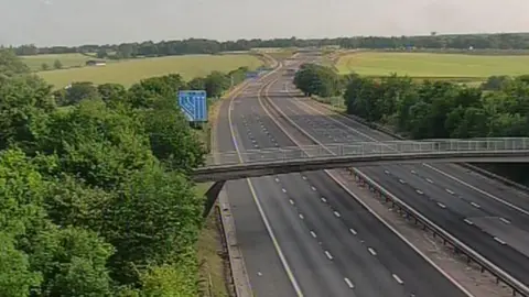 An empty M11, showing both carriageways in both directions devoid of traffic after an accident. 