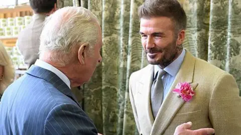 Getty Images David Beckham wearing a David Austin Roses "King's Rose" speaks with King Charles III, patron of the Royal Horticultural Society