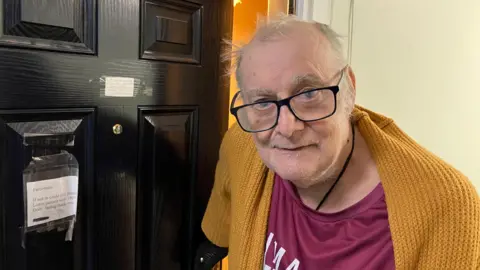 Man in front of door.