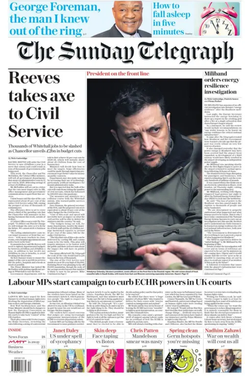 A front page of the Sunday Telegraph shows Ukrainian President Volodymyr Zelensky staring seriously into the distance, while a headline next to his face reads: Reeves takes axe to Civil Service.