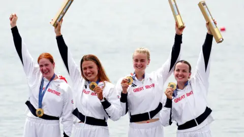 PA Media Great Britain’s Lauren Henry, Hannah Scott, Lola Anderson and Georgie Brayshaw celebrate with their gold medals following the Women's Quadruple Sculls Final at the Paris Olympics.