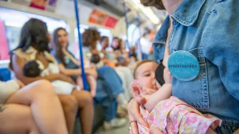 PA Media A group of women breastfeeding on a Tube