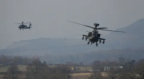 Derrick Tipple Two military helicopters flying by