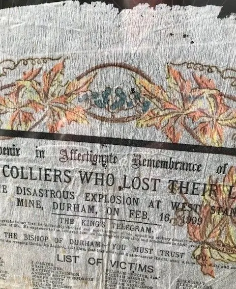 Beamish A paper serviette which has a leaf pattern on it. It show what was written on it, including words from a telegram from the King. It also has a list of victims. The wording is partially obscured.