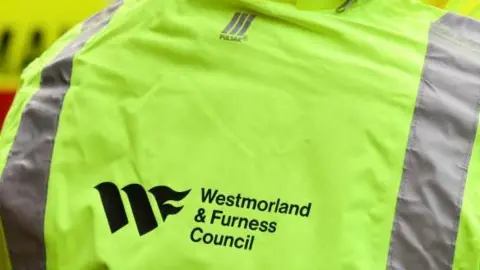 Westmorland and Furness Council A worker wearing a Westmorland and Furness Council high visibility jacket.