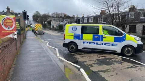 BBC A police van parked across the street in Dunfermline.