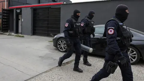 Reuters Police officers outside the Tate brothers residence in Pipera, Ilfov, near Bucharest, Romania, August 21, 2024