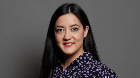 UK Parliament Sarah Owen in blue dress