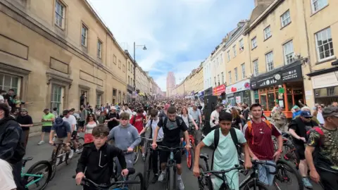Hundreds of people on bikes in a road in Bristol.