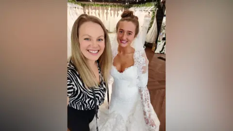 Sew In Love Emily Grant has long blonde hair and wears a zebra tolp and blakc tgrousers while Venezuela Fury is in her wedding dress