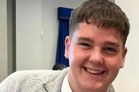 Police Scotland A male teenager wearing a grey top smiles at the camera