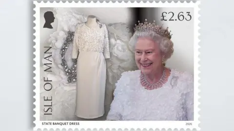 IOMPO/ROYAL COLLECTION The white dress alongside the Queen wearing it, she is also wearing a tiara and necklace.