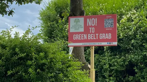 A campaign sign reading "No to green belt grab" in Albrighton