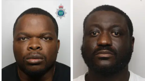 Two men with dark hair and dark-coloured beards are pictured with neutral expressions in front of a neutral-coloured background. Peter Nwankwo is pictured in a black t-shirt, while Lamin Jallow is wearing a white t-shirt.