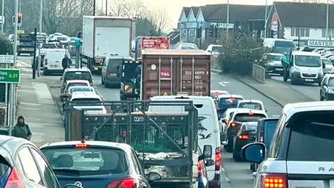 Eddie Mitchell a queue of traffic 