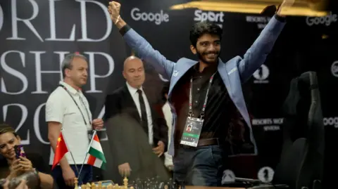 EPA Chess grandmaster Gukesh Dommaraju of India celebrates after winning Game 14 against Ding Liren (not pictured) of China at the FIDE World Chess Championship in Singapore, 12 December 2024