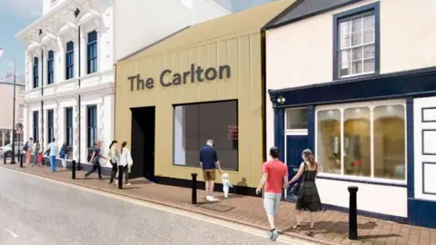 Cumberland Council Artist's impression of the new entrance and box office to the Carlton Cinema. The single story building, clad in yellow material with a large square window, is labelled The Carlton. To the left is the high white 18302 building, and a low rise building to the left. People are walking on the street in front of it.
