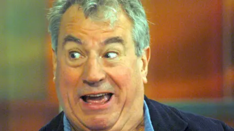 A photo of Terry Jones smiling taken from a BBC Television interview