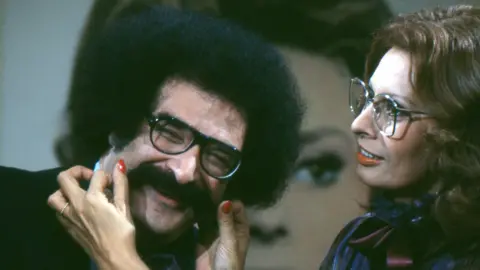 Journalist Gene Shalit smiles as actor Sophia Loren pulls his moustache on the 'Today Show' set at NBC Studios.