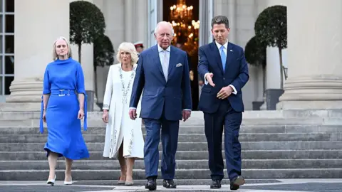 Samir Hussein via Getty Images Claire Turner, Queen Camilla, King Charles III and Sir Christian Turner, British ambassador to the US, attend the garden party at the British Embassy in Washington DC.