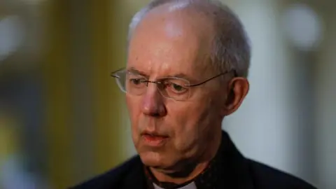 Archbishop of Canterbury Justin Welby speaks with the press after a visit to the grave of Saint Oscar Arnulfo Romero, during a visit to El Salvador, at The Metropolitan Cathedral in San Salvador, El Salvador, June 4, 2024. He is wearing a black jacket and glasses