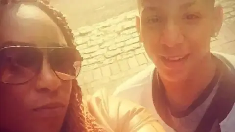 Met Police A mother and her teenage son pose for a selfie - she is wearing sunglasses and the boy is smiling