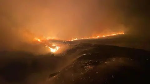 Fires burn in the dark in Cairngorms national park.