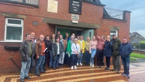 Residents outside miners' welfare hall in Great Houghton