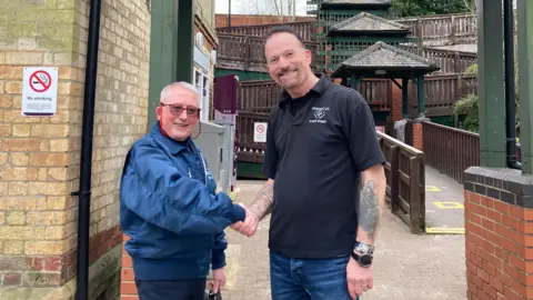 Tony Sherwood shaking hands with David Sanderson-Cole at Gainsborough Lea Road railway station