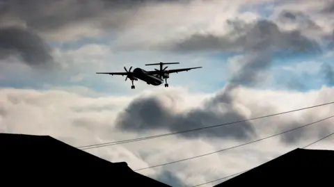 Getty Images A plane in the skies above Birmingham Airport