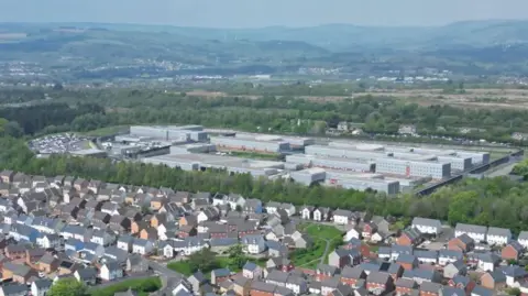 An aerial shot of HMP Parc with residential houses seen in front of it.