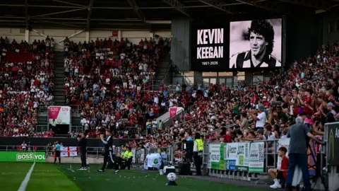 Getty Images Fans are packed into stands at Ashton Gate Stadium either side of a large screen showing a tribute to Kevin Keegan before the Bristol City v Newcastle match