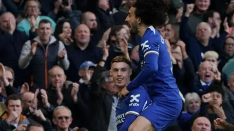 Getty Images Cole Palmer with Marc Cucurella jumping on him 