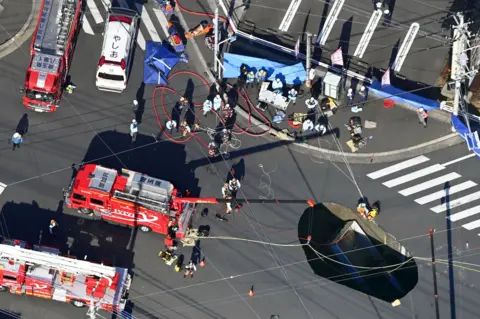 Reuters one aerial view indicates the operation of the rescue on a large synchron, which swallowed a truck at a crossroads in north of Tokyo on 28 January 2025, north of Tokyo.