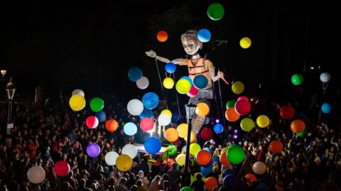 Puppet surrounded by balloons
