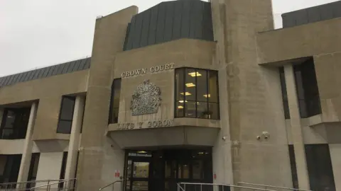 BBC The grey exterior of Swansea Crown Court  