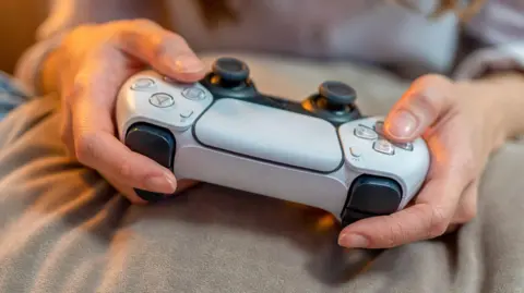 Woman holds Xbox controller 