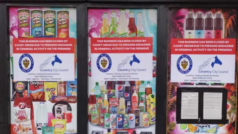 Images of products including drinks and crisps are next to three notices including the words this business has been closed by court order due to persons engaging in criminal activity on the premises.