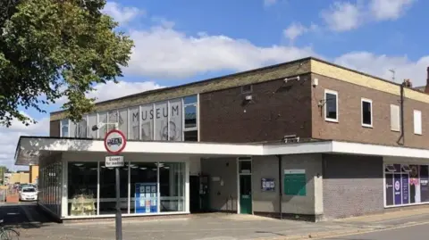Goole Library - a large grey and red brick building with full-length windows and an overhanging canopy.
