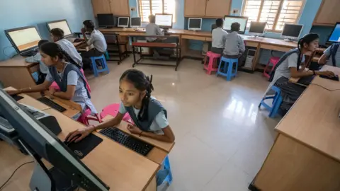 Bhasker Solanki Children work at computers in a classroom