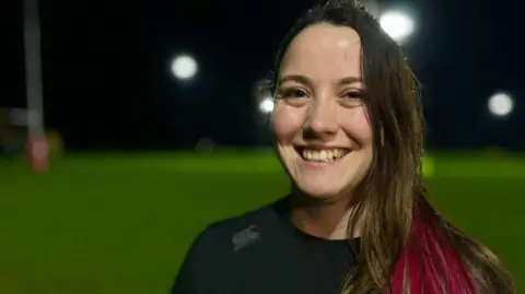 Martin Giles/BBC Tabby Pickup on a rugby training ground in Cambridge