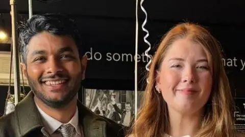 A close-up, head and shoulders image of Gouse Subhan Saheb and Katie Molloy. They are both smiling and looking into the camera. 
