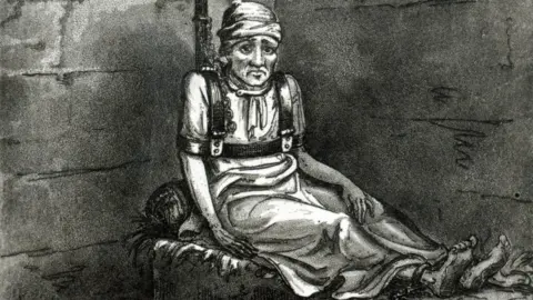 Getty Images Vintage illustration showing a man bound and chained to a pipe, sitting on a straw mattress in a cell