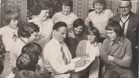 Keith Batt Harry Batt is leading a tactic session with Chiltern Valley Ladies. They are gathered around him. 