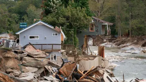 Getty Images Destroyed houses and buildings along the Broad River in the aftermath of Hurricane Helene in Bat Cave, North Carolina